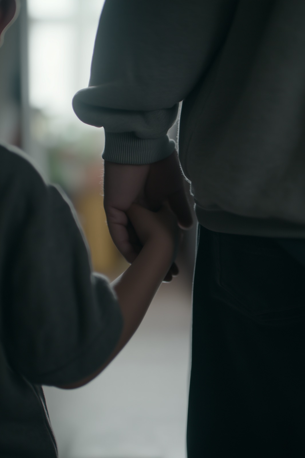 A child holding a parent's hand